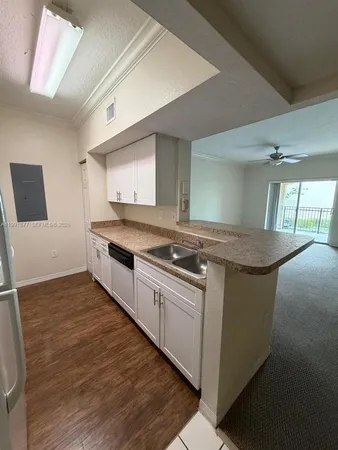 a kitchen with stainless steel appliances granite countertop a stove and a sink
