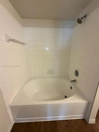 a bathroom with a granite countertop sink a mirror and vanity