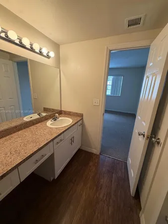 a spacious bathroom with a granite countertop sink