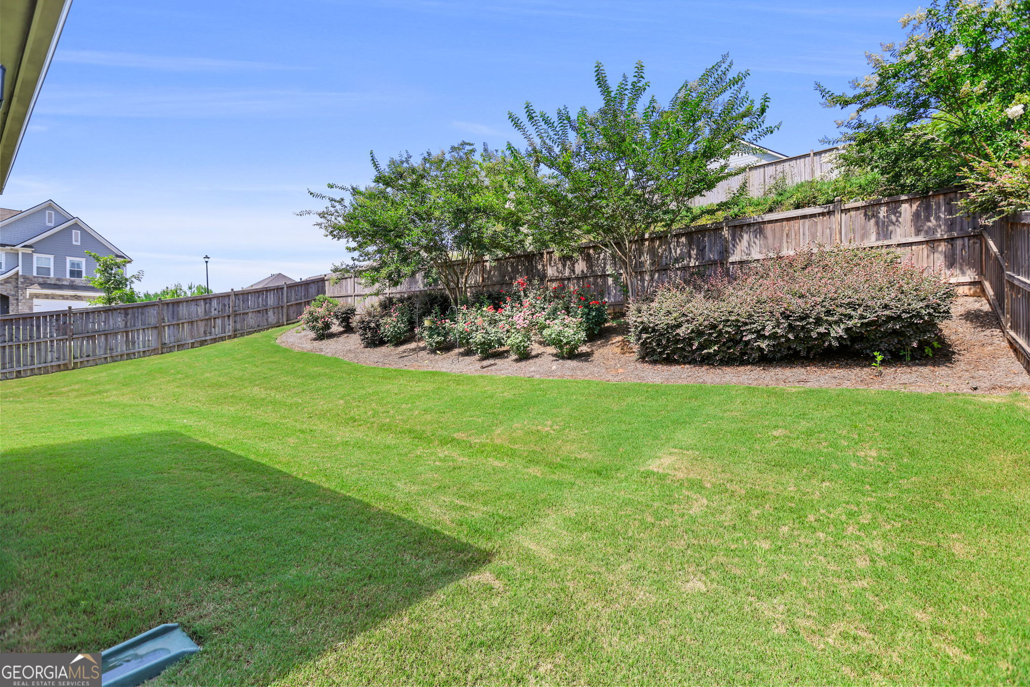 4605 Dandelion Way Cumming, GA 30040 - Photo 11 of 54 a view of a backyard with plants and a garden