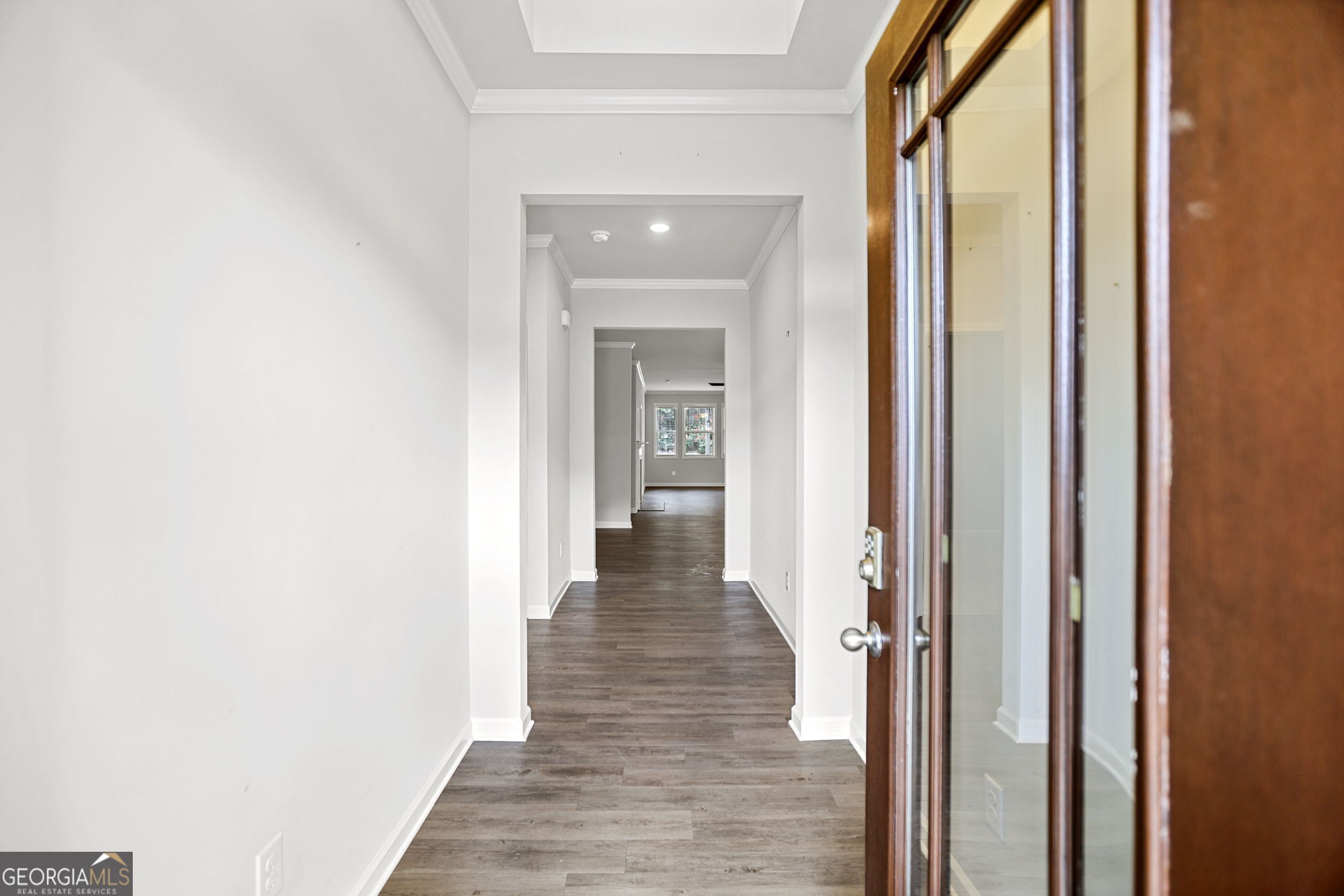 4605 Dandelion Way Cumming, GA 30040 - Photo 13 of 54 a view of a hallway with wooden floor and staircase