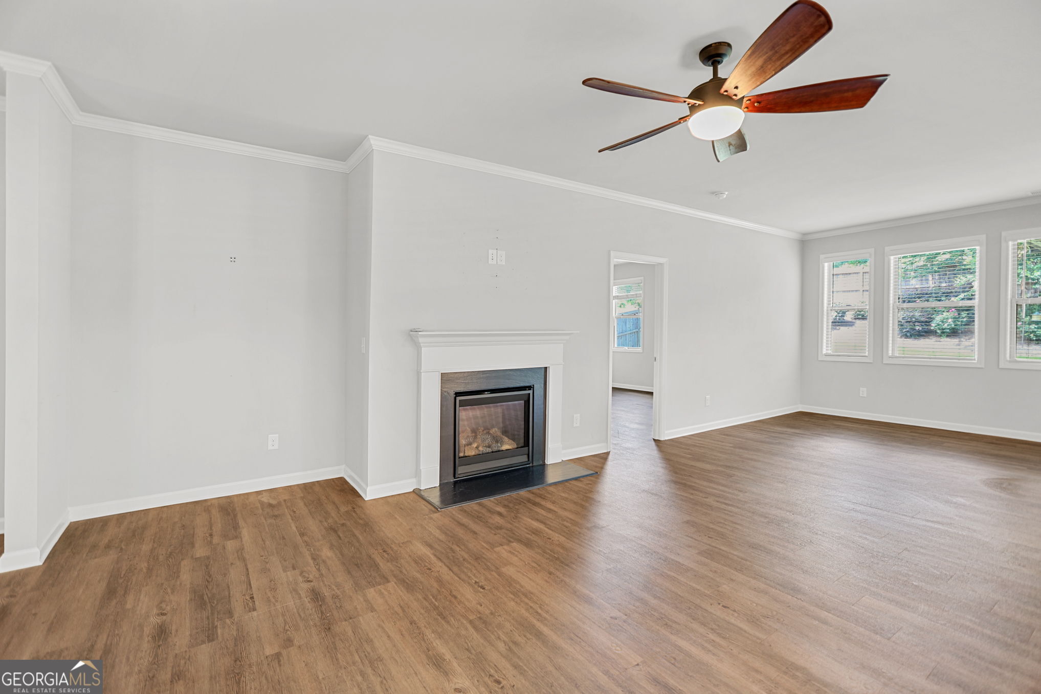 4605 Dandelion Way Cumming, GA 30040 - Photo 20 of 54 an empty room with wooden floor chandelier fan and windows