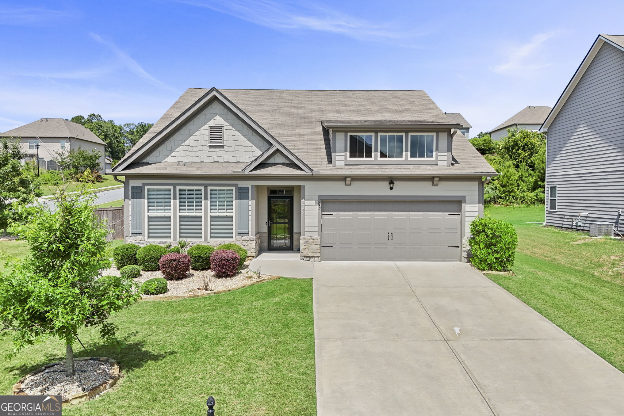 4605 Dandelion Way Cumming, GA 30040 - Photo 2 of 54 a front view of a house with garden
