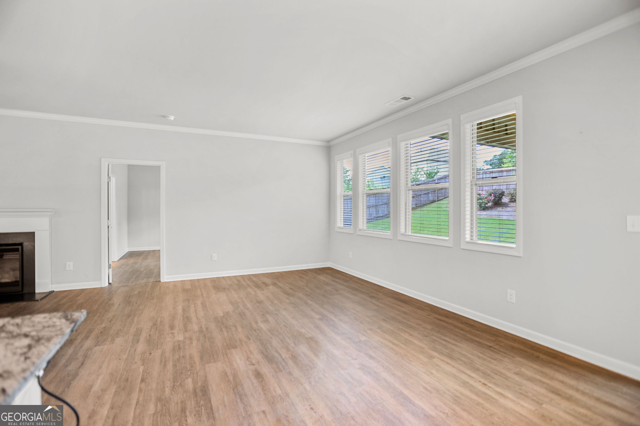 4605 Dandelion Way Cumming, GA 30040 - Photo 26 of 54 a view of an empty room with wooden floor and a window