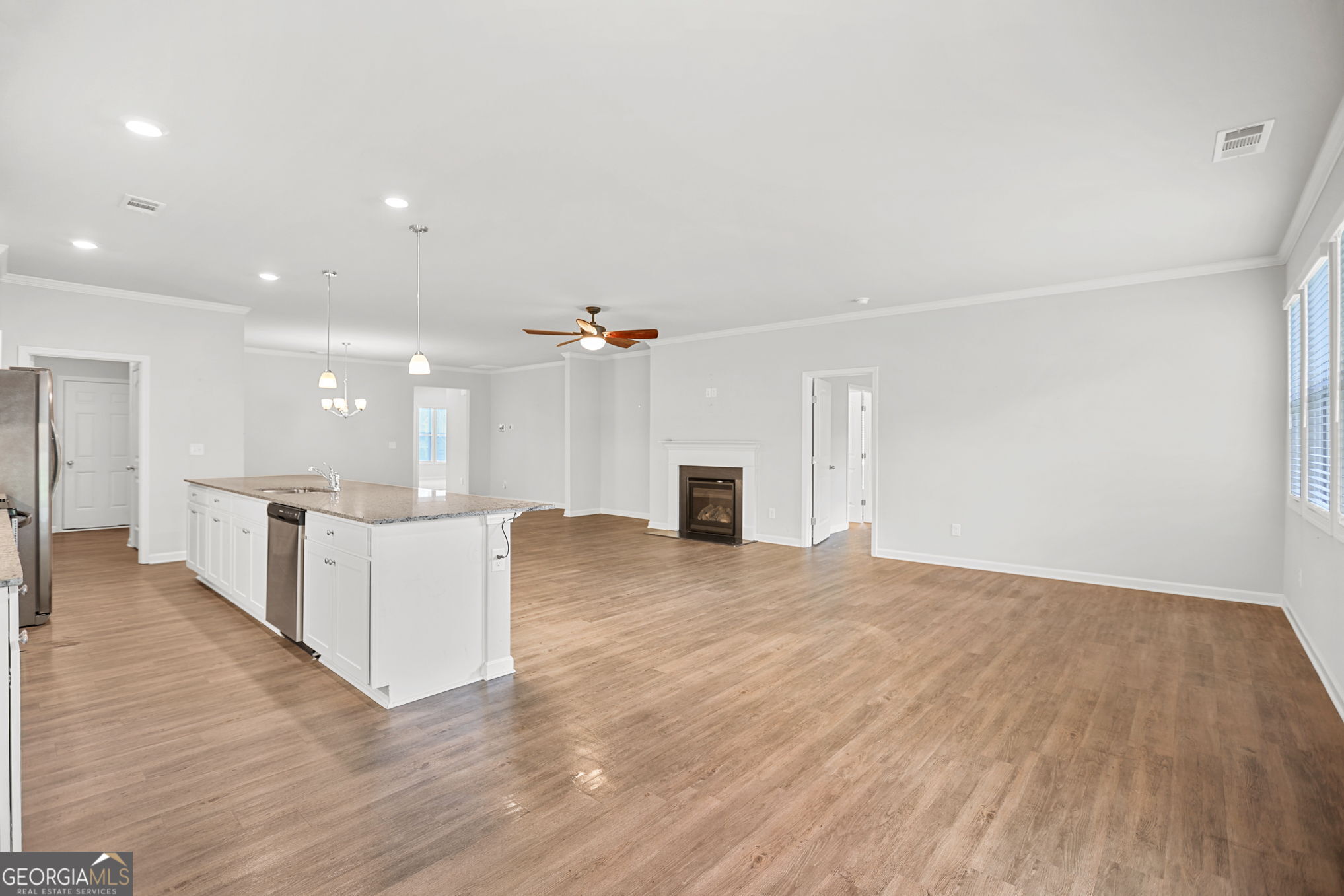 4605 Dandelion Way Cumming, GA 30040 - Photo 27 of 54 a view of kitchen with wooden floor and fireplace