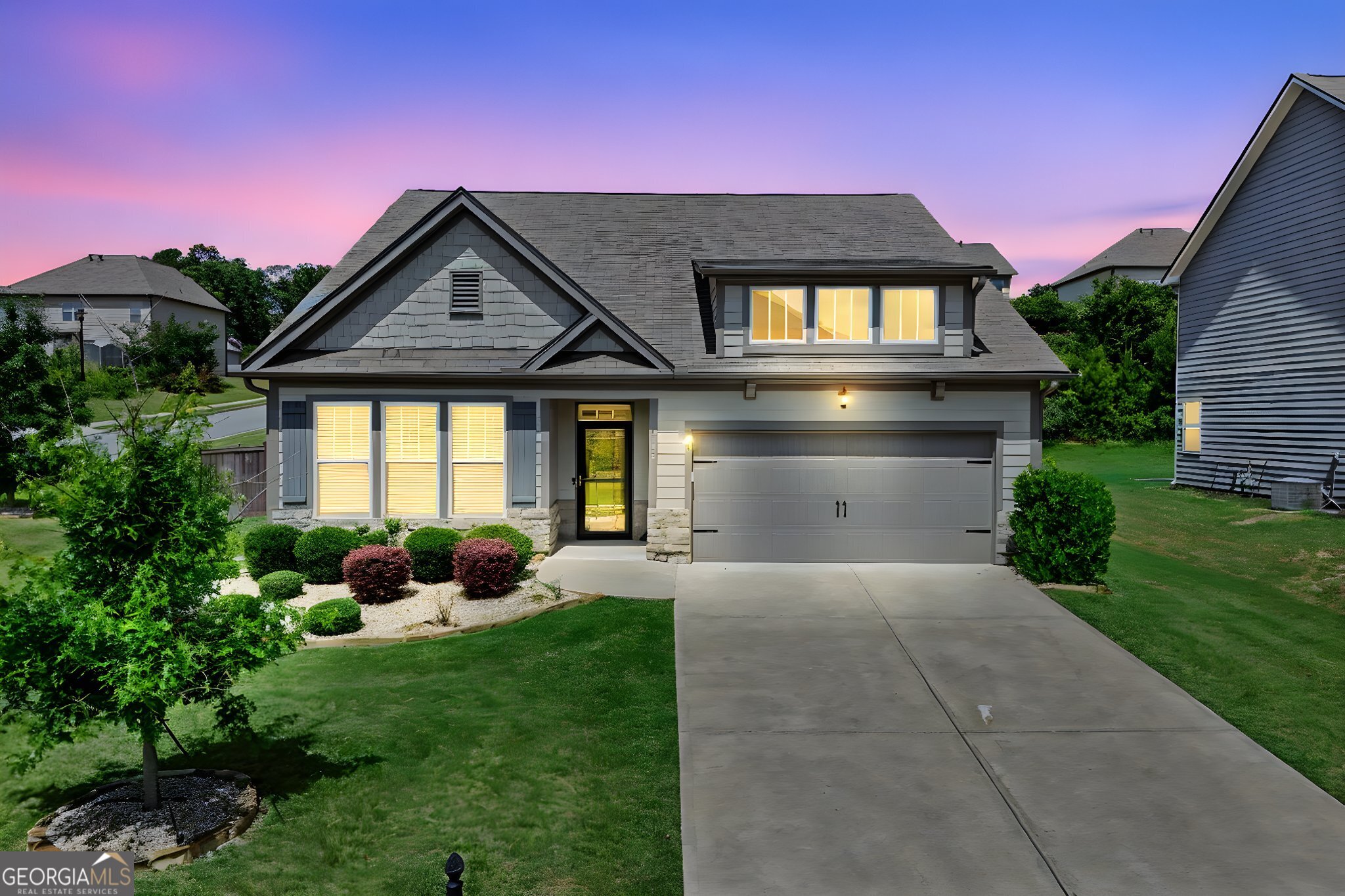 4605 Dandelion Way Cumming, GA 30040 - Photo 3 of 54 a front view of a house with garden