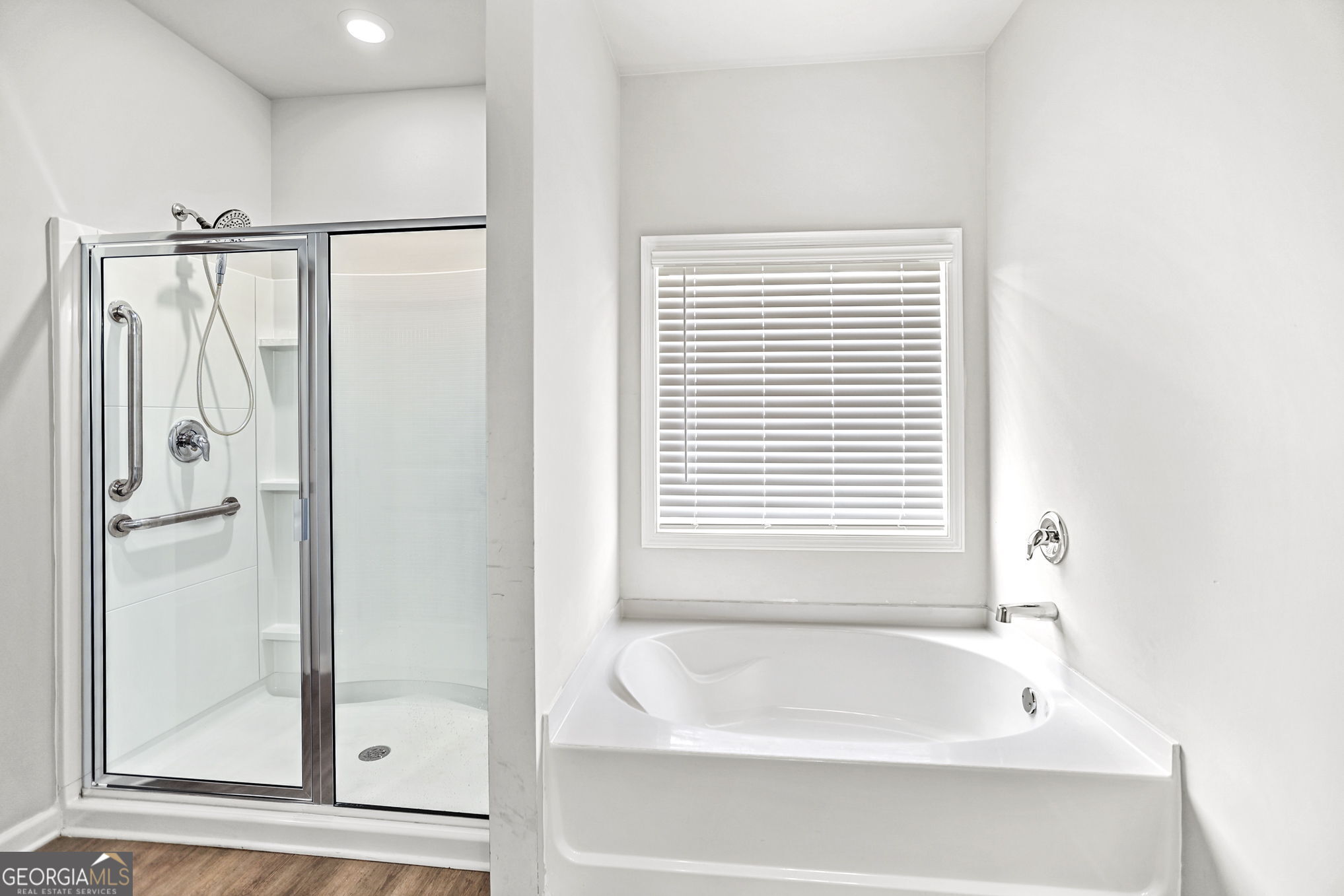 4605 Dandelion Way Cumming, GA 30040 - Photo 35 of 54 a bathroom with a bathtub and a shower