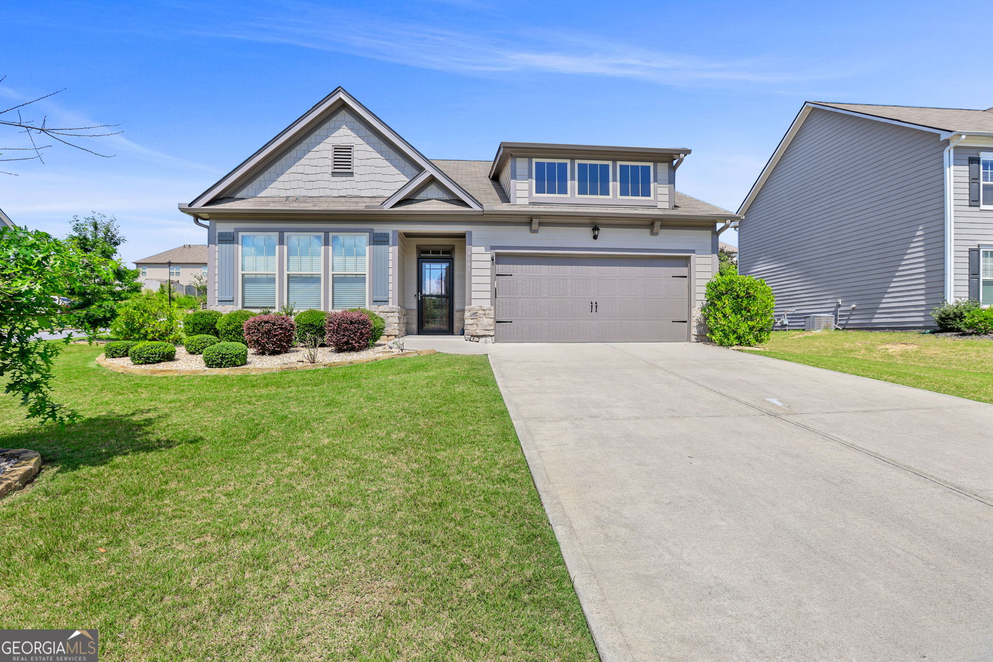 4605 Dandelion Way Cumming, GA 30040 - Photo 4 of 54 a front view of a house with garden