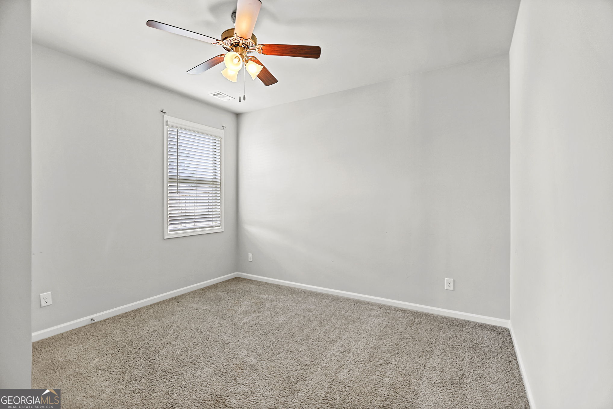 4605 Dandelion Way Cumming, GA 30040 - Photo 43 of 54 an empty room with windows and fan