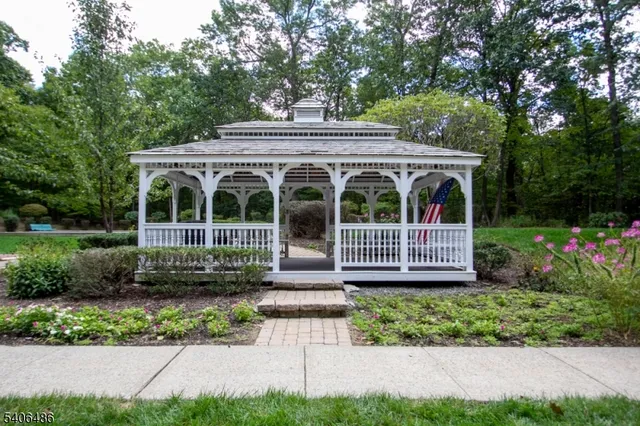 a view of a house with a small yard and flower plants