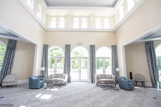 a living room with furniture and large windows