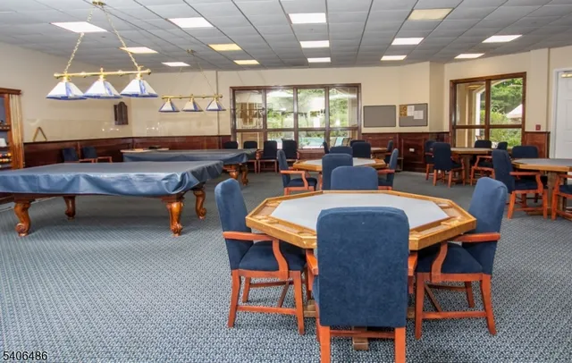 a living room with furniture a large window and kitchen view