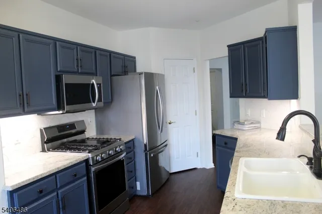 a kitchen with wooden cabinets and stainless steel appliances