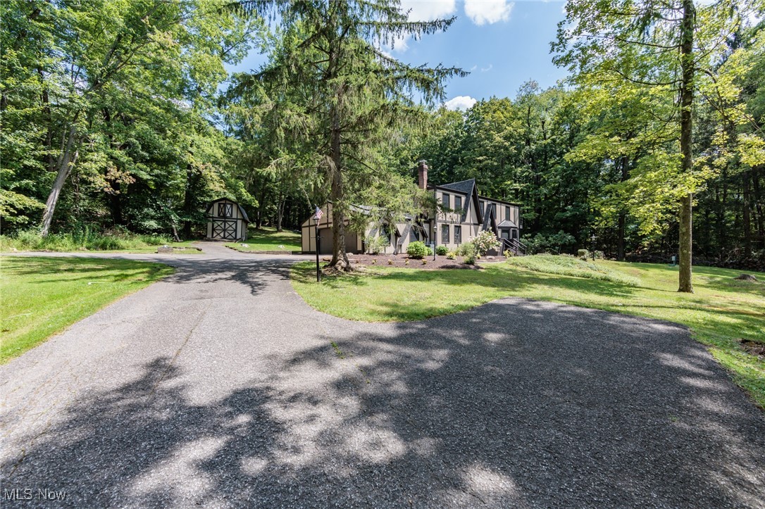 13655 Sperry Road Novelty, OH 44072 - Photo 30 of 32 View of asphalt driveway featuring a barn and view of wooded area
