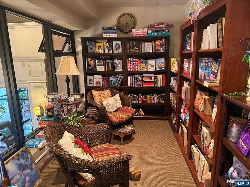 265 Main Street, Unit 702 Ridgefield Park, NJ 07660 - Photo 6 of 20 a view of living room filled with furniture and book shelf