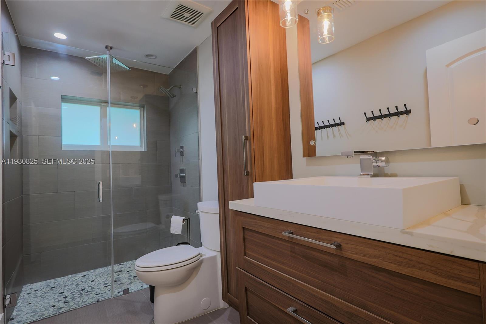 9870 Southwest 96th Street Miami, FL 33176 - Photo 6 of 13 a bathroom with a sink a toilet and shower