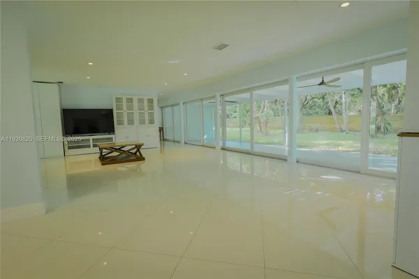 a view of a livingroom with workspace and a window