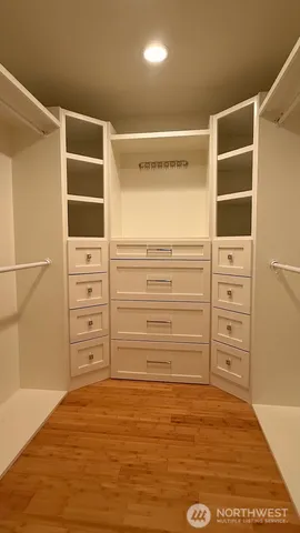 a spacious bathroom with a granite countertop sink a mirror and shower