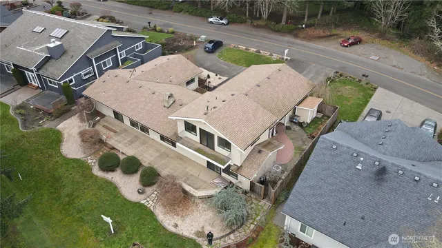 an aerial view of a house with a yard