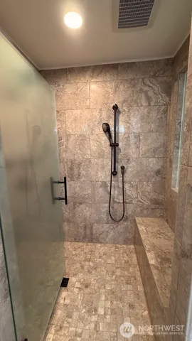 a bathroom with a tub shower and sink
