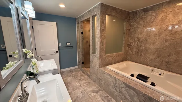 a spacious bathroom with a double vanity sink and a mirror
