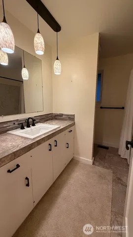 a bathroom with a sink a toilet and mirror