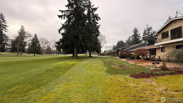 a view of a tree in front of a house