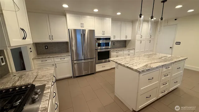 a kitchen with a refrigerator and a sink