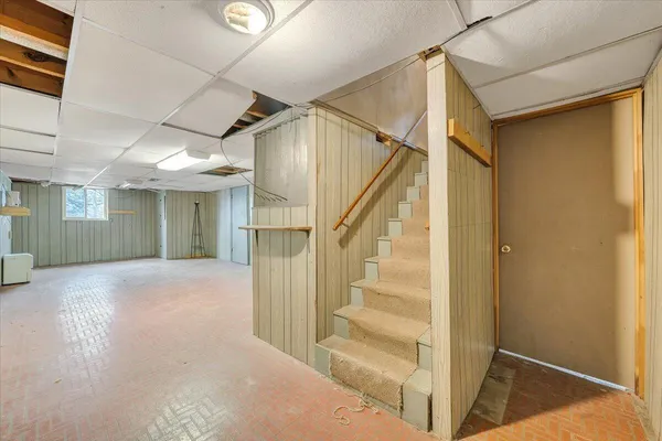a view of empty room with fireplace and windows