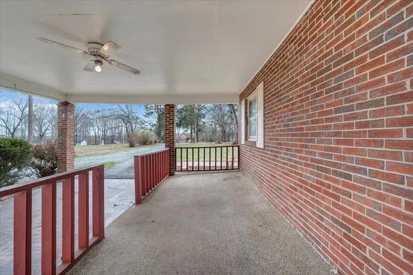 a view of a porch with wooden floor and outdoor space