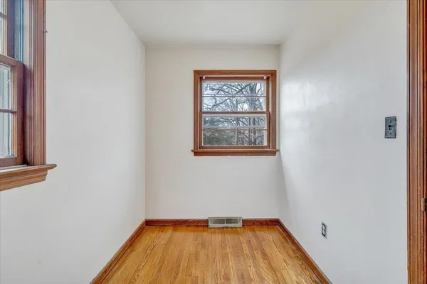 a view of a room with wooden floor and a window