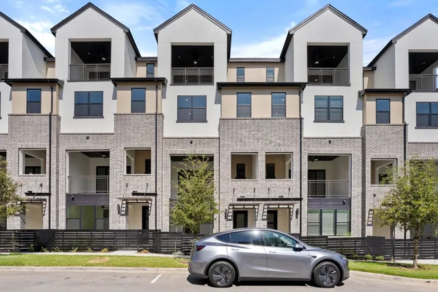 a car parked in front of a brick house