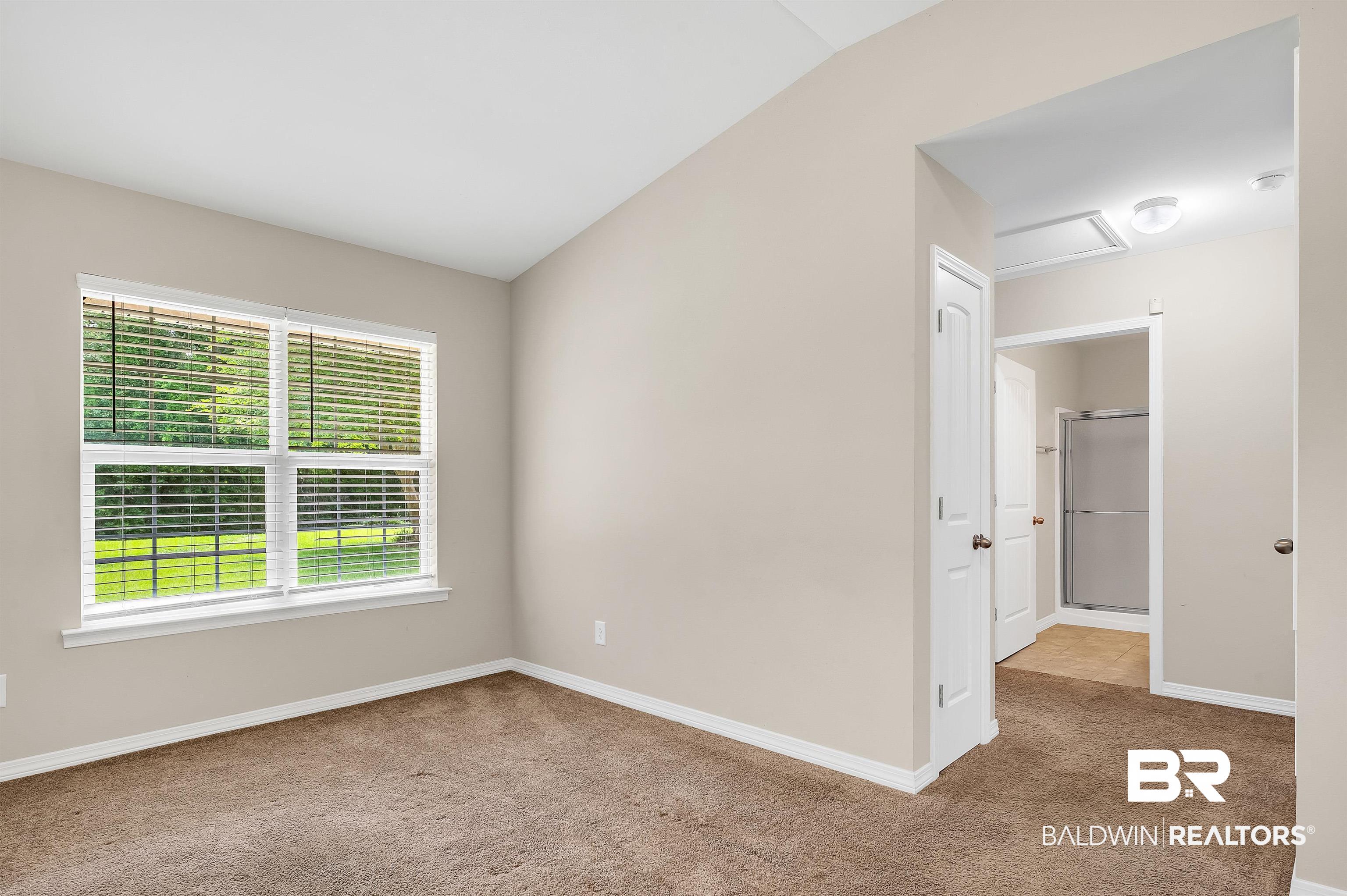 22810 Ard Road Robertsdale, AL 36567 - Photo 40 of 65 Empty room with carpet flooring, attic access, and vaulted ceiling