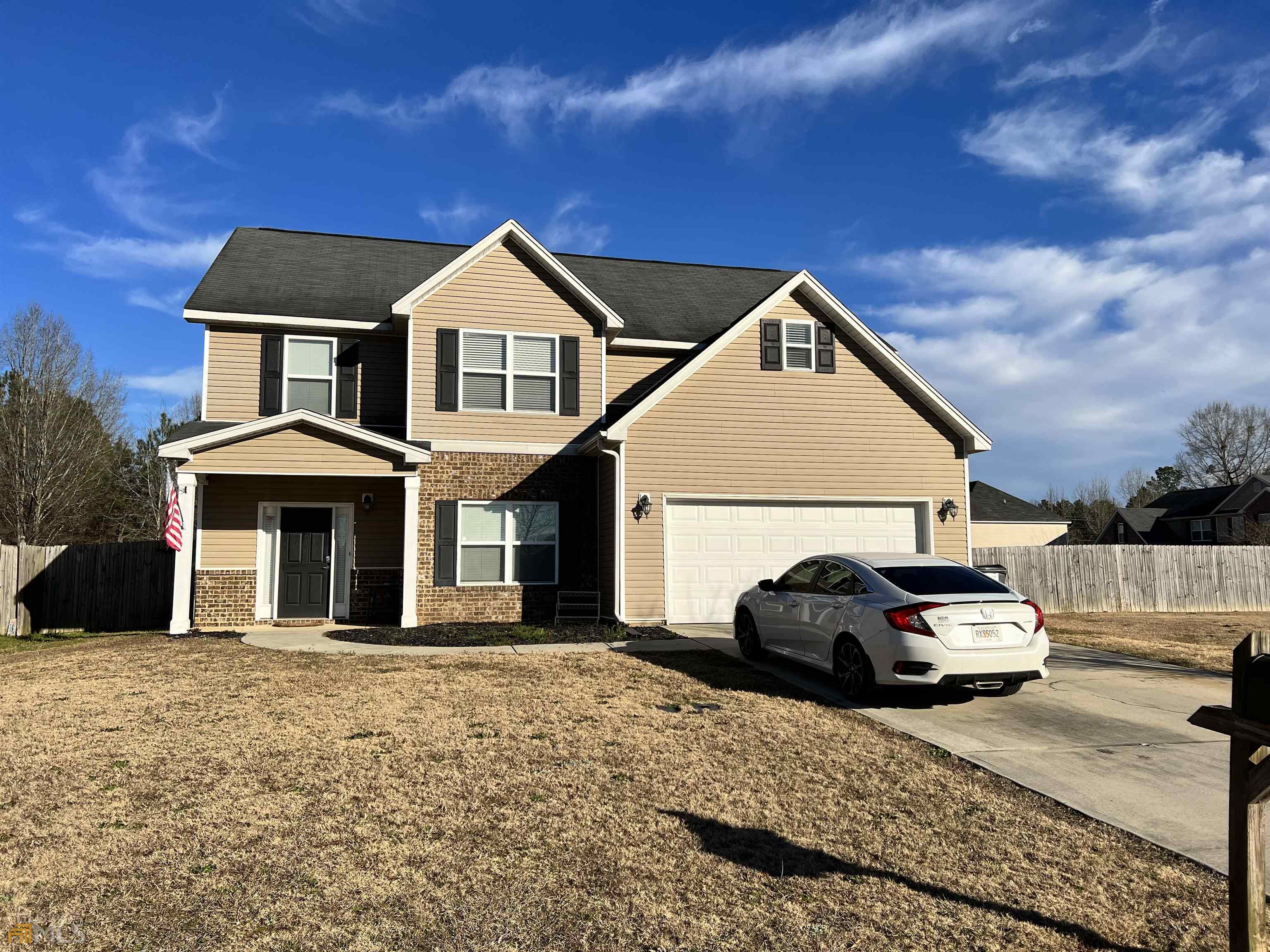 102 Ousley Way Perry, GA 31069 - Photo 1 of 1 a front view of a house with a yard