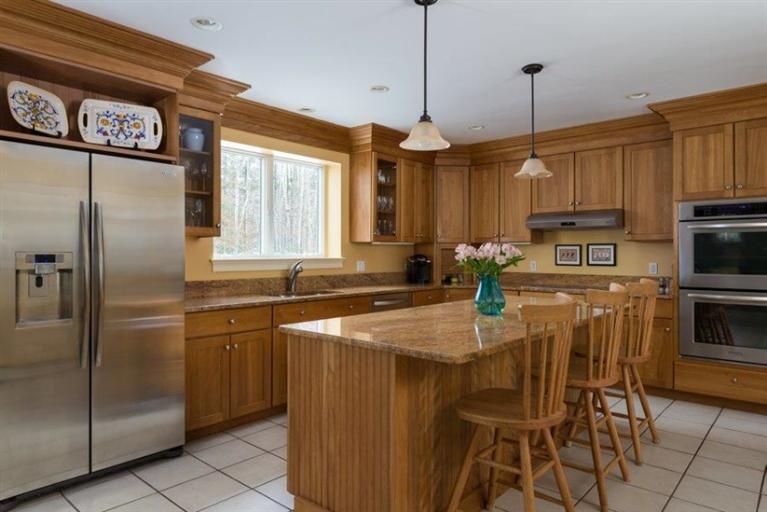 104 Paradise Lane Rochester, MA 02770 - Photo 2 of 15 a kitchen with stainless steel appliances granite countertop a refrigerator a sink a stove and island