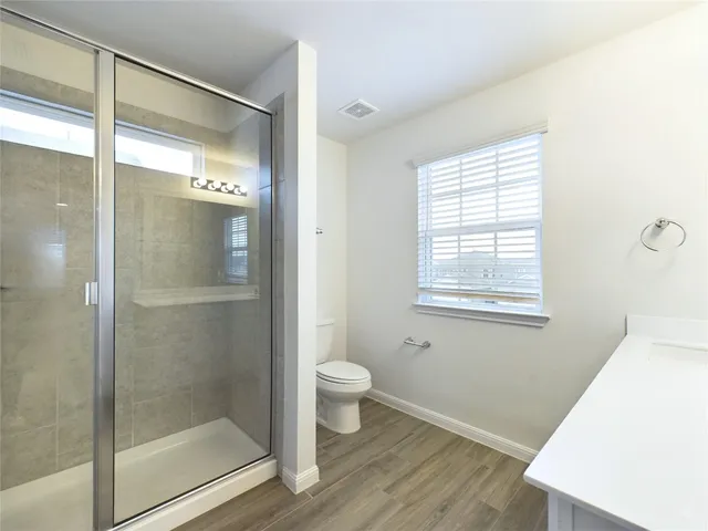 a bathroom with a glass shower door