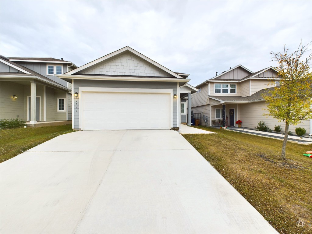 10817 Timber Brook Pass Austin, TX 78747 - Photo 2 of 23 a front view of a house with a yard and garage