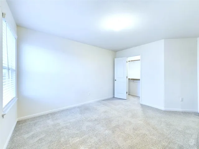 a view of an empty room and a window