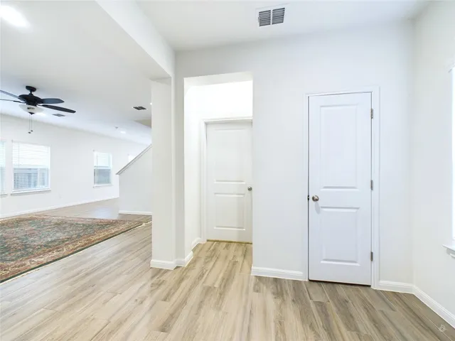 a view of hallway with wooden floor
