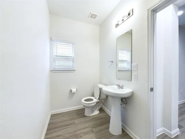 a bathroom with a sink toilet and a mirror