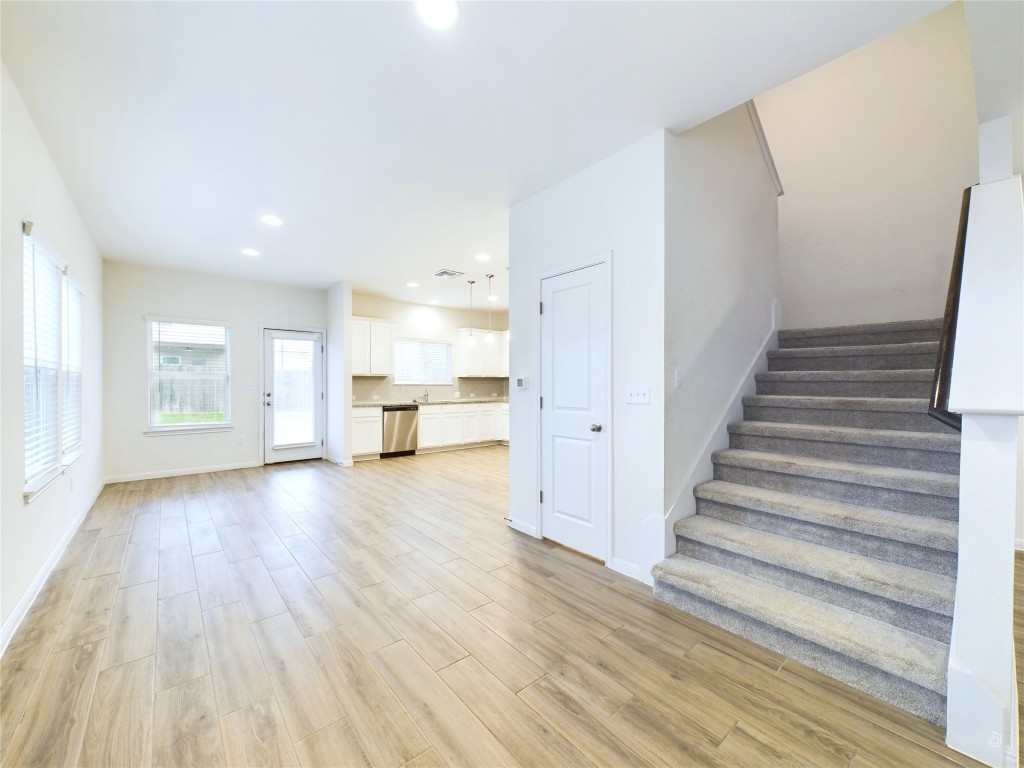 10817 Timber Brook Pass Austin, TX 78747 - Photo 7 of 23 a view of an empty room with wooden floor and a window