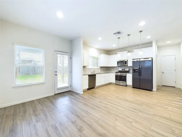 a view of kitchen with wooden floor