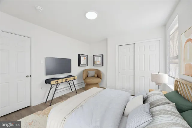 a bedroom with a bed and a chair