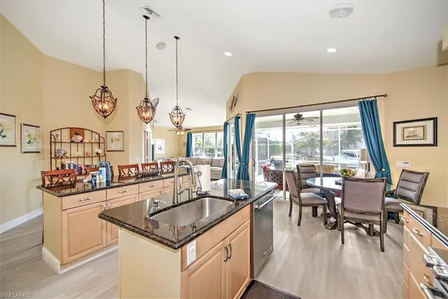 a kitchen with stainless steel appliances granite countertop sink stove and wooden floor