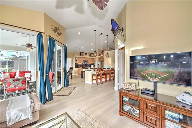 a view of a living room with furniture and a flat screen tv