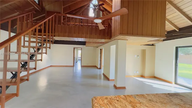 a view of a room with wooden floor