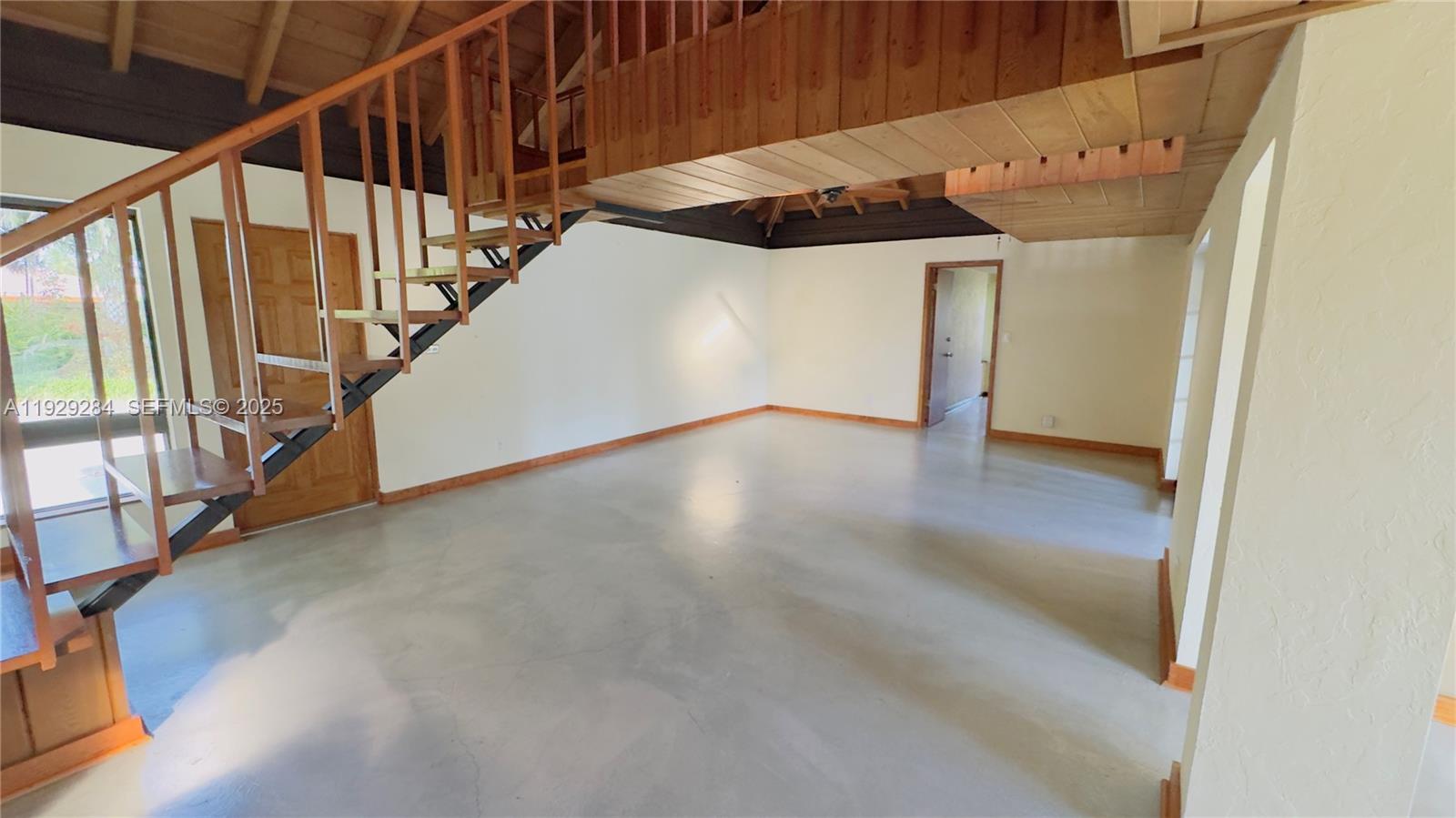 18350 Southwest 214th Street Miami, FL 33187 - Photo 19 of 24 a view of an empty room with wooden floor