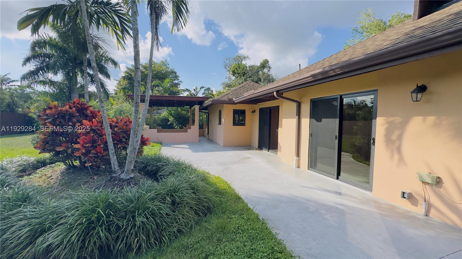 18350 Southwest 214th Street Miami, FL 33187 - Photo 20 of 24 a view of a house with a patio