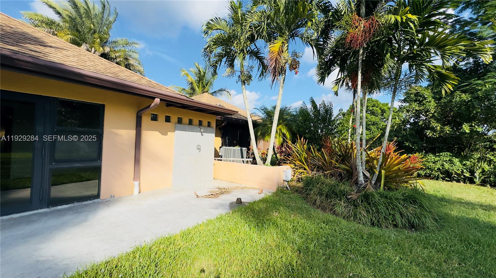 18350 Southwest 214th Street Miami, FL 33187 - Photo 24 of 24 a front view of a house with a yard and a garage