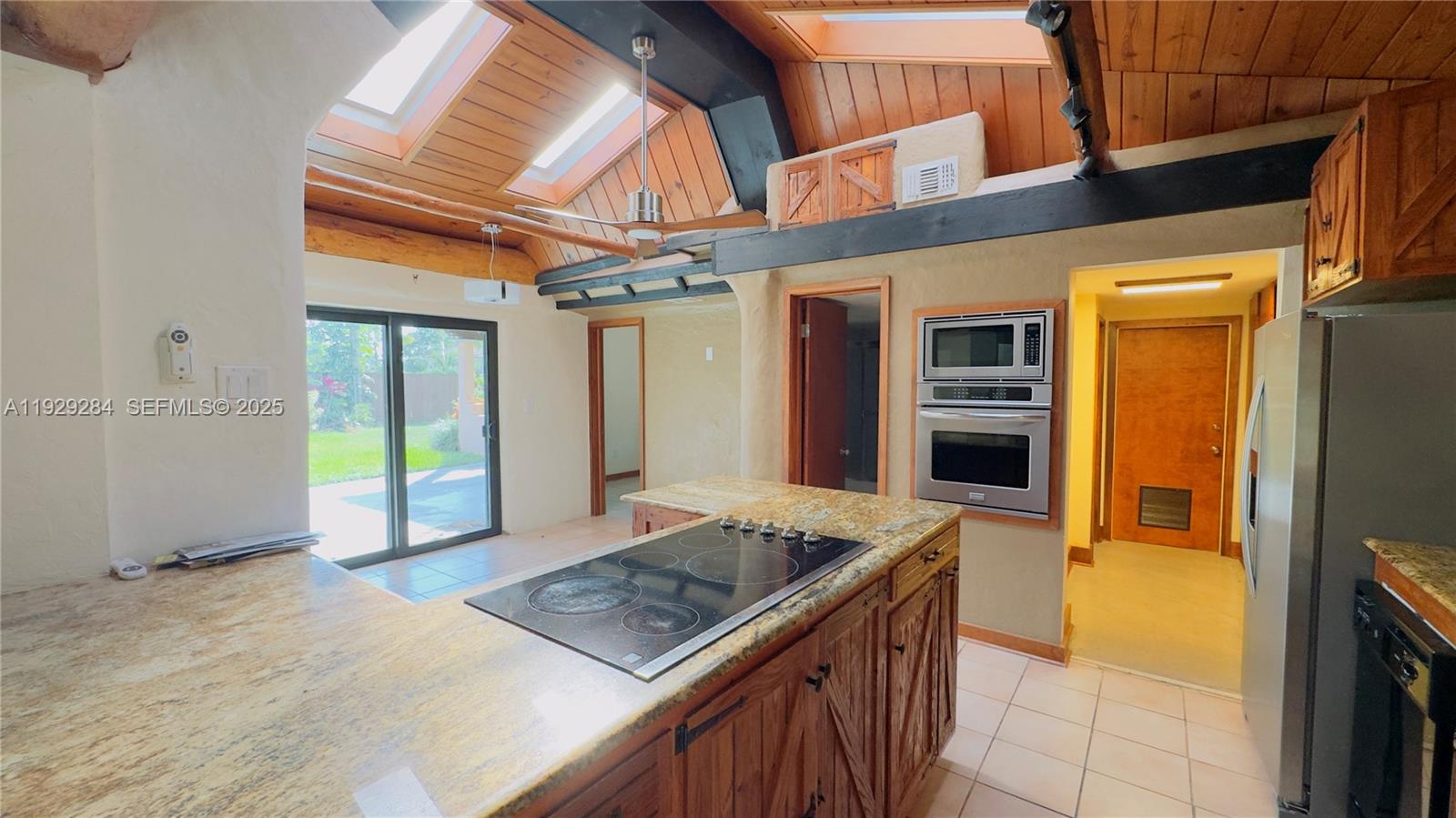 18350 Southwest 214th Street Miami, FL 33187 - Photo 3 of 24 a kitchen with stainless steel appliances granite countertop a sink stove and refrigerator